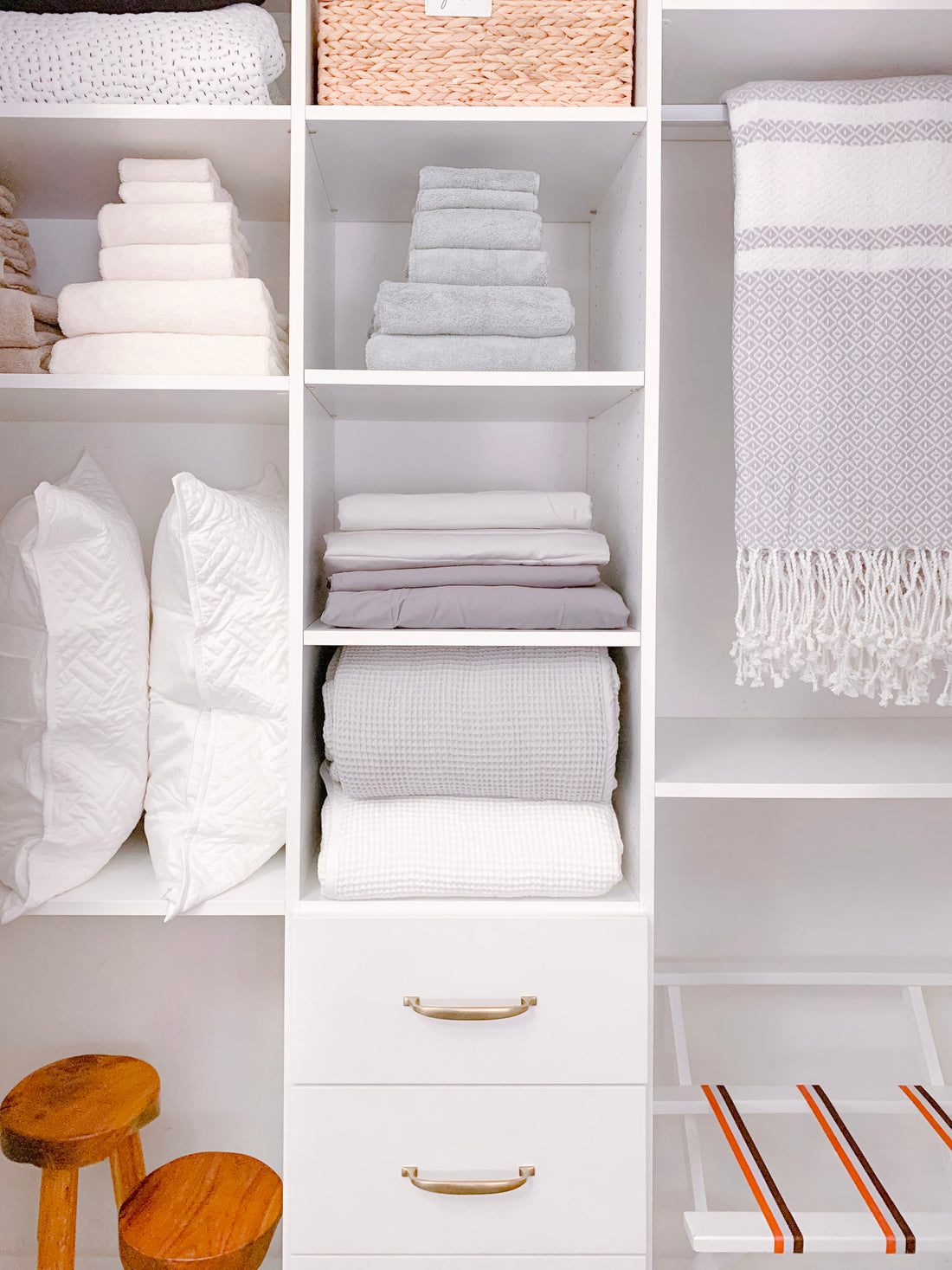 organizing linen closet: hamper, drawers, totes, hanging rack